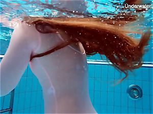 ginger-haired Simonna showcasing her bod underwater